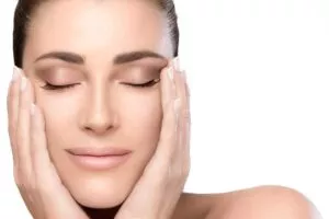 hands on cheeks and eyes closed with a serene expression in a beauty