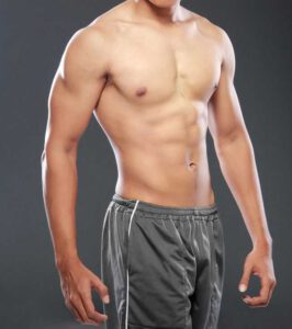 20599585 - a young and fit male model posing his muscles